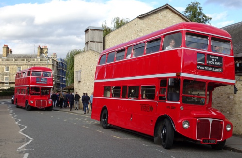 A pair of Open Platform Routemasters next to the river Cam