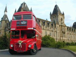 Curvy bus against gothic building - Royal Victoria Patriotic Building, Wandsworth Common