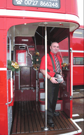 Bus conductor wearing ticket machine in harness